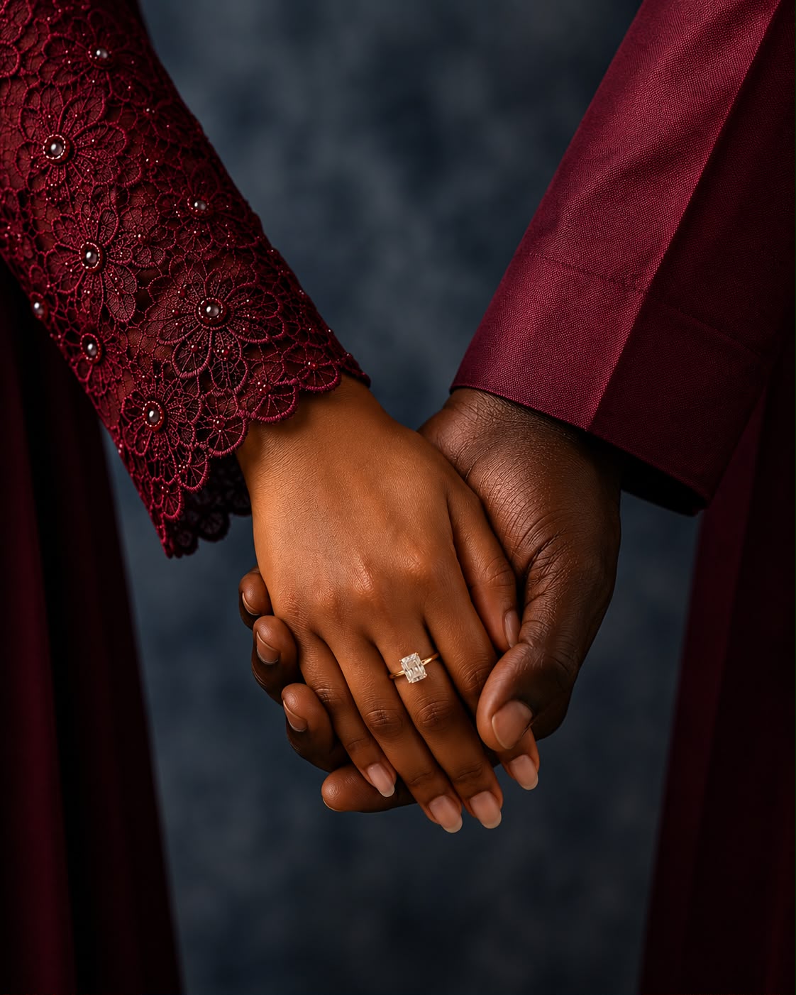 The couple's joined hands with the engagement ring